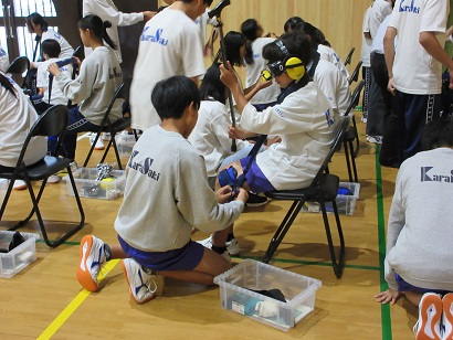 高齢者疑似体験グッズをつける生徒